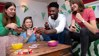 A group of friends laughing and smiling while playing fundraising games.