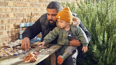 Father plays in the garden with his son
