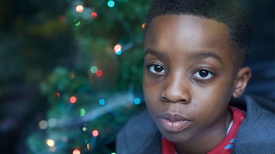 Young boy alone at Christmas