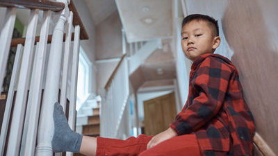 Chinese boy sitting on staircase