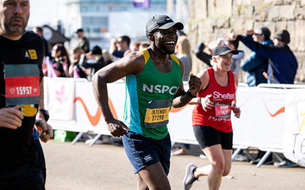 Team NSPCC runner passing a cheering point