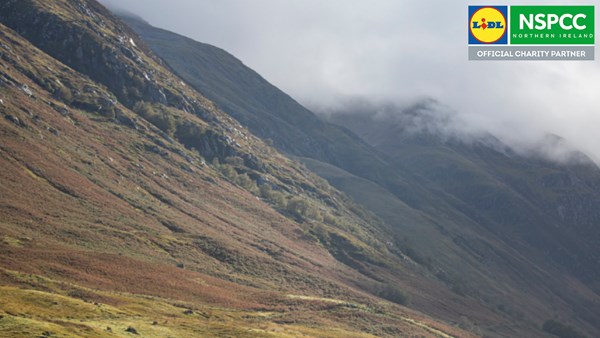 Mountain landscape layered with NSPCC/Lidl Northern Ireland official partnership logo