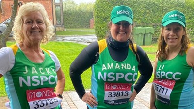 Amanda Synott and some friends smiling in their personalised running gear.