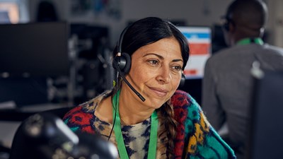 An NSPCC child protection specialist smiling on a Helpline call.