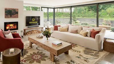 Omaze Cotswolds house lounge with large sofa and floor-to-ceiling windows