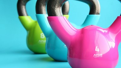 multi-coloured kettle bells on a blue background