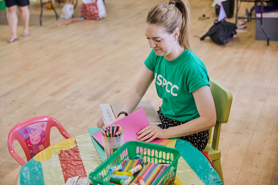 Young woman sat down preparing children's activities for an event